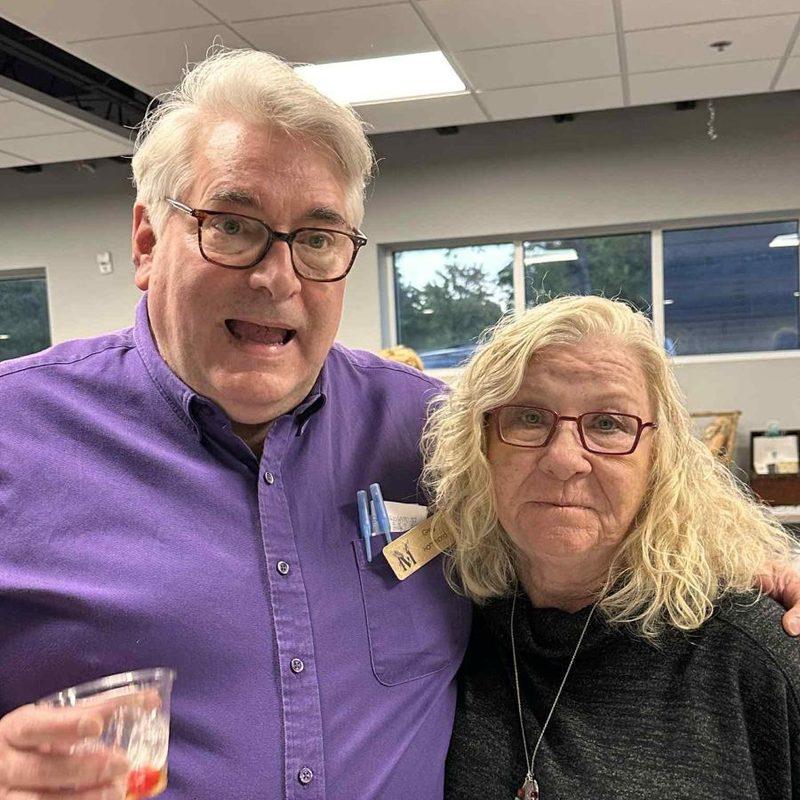 Two guests sharing a drink and a laugh