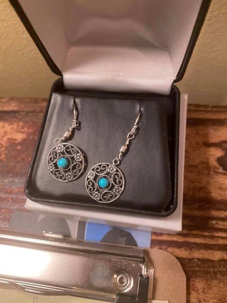 Silver and turquoise earrings in a jewellery box.