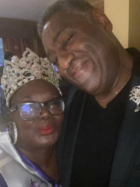The Queen in a crown beside a guest.